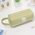 Light green canvas pencil case with dual zippers and handle featuring sunshine print - With Letter Label / Green