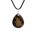 Macro detail of natural tiger eye stone pendant with carved Hamsa Hand and Evil Eye - Tiger Eye/Wax Cord
