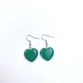Detail view of heart-shaped malachite stone earrings with silver metal hooks for women - Peacock