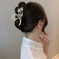 Detail of elegant gold tulip hair claw with sparkling rhinestones worn on a bun - Double Tulip Claw Clip Light Gold