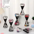 Hexagon liquid timer with black oil and silver stars featuring cartoon figures - Diamond Shape Liquid Hourglass