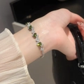 Detailed close-up of a silver multi-layer bracelet with green oval gemstones on a wrist - Oval Main Stone with Pave Diamonds Multi-layer Design (3#) / Silver