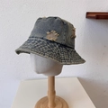 Retro distressed blue denim bucket hat with frayed holes on a minimalist stand - One Size / Light Blue
