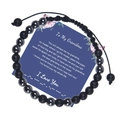 Detail of Morse code bracelet with matte black beads on blue message card - Grandma