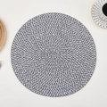 Detailed view of the black and white woven texture on a round heat-resistant placemat - Black & White