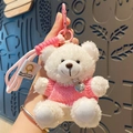 Plush white bear keychain with pink sweater and heart pendant in hand display - White/Pink Outfit Plush Bear