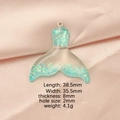 Resin mermaid tail pendant with teal sequins and dimension specs on pink fabric - Blue Green Gradient (5)