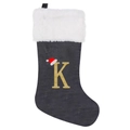 Detail of black Christmas stocking with white faux fur cuff and gold glitter letter K - Letter K