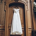 Elegant white satin off-shoulder wedding dress with a cinched waist and full flowing skirt - US Size 2 (S) / Ivory