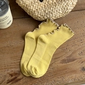 Bright yellow ribbed cotton crew socks with vintage ruffled edges on a wooden surface - One Size / Yellow