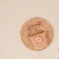 Pink hand-woven straw crossbody bag with a plaid fabric flower and shoulder strap - Pink