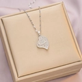 Silver double heart necklace with sparkling crystals displayed on a golden jewelry box - 6059 Double Heart Design / Silver
