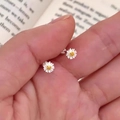925 silver plated daisy stud earrings with white petals and yellow centers on a book - Daisy Shape Stud Earrings (A239)