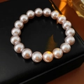 Macro detail of elegant pink pearl bracelet with high luster on a black jewelry box - Pink 10mm Large Bead Style