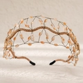 Macro detail of hand-woven bridal headband with amber crystals and gold rhinestones - Champagne