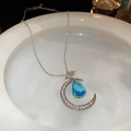 Close-up of crescent moon necklace with white zircons and a blue waterdrop gemstone - Silver Star Moon Teardrop Necklace