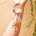 Detailed suncatcher with moon and crystal stones displayed on a person's arm - Blue Spot Stone