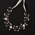 Detailed view of handmade bridal headband with pearls, crystals, and delicate flowers - Rose Gold Copper Version / Rose Gold