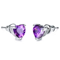 Close-up of elegant purple heart-shaped zircon earrings with polished silver prongs - Purple Zirconia