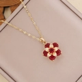 Layered gold flower necklace featuring red zircon petals in a beige leather jewelry box - Red