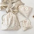 Detail of three sizes of cartoon drawstring bags in textured bubble fabric on marble - Small (14x15cm) / Star Rabbit