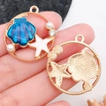 Round golden pendant set with blue shell, white starfish, and pearl charms for DIY jewelry - Blue Starfish Large Shell