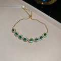 Adjustable gold plated bracelet with emerald green stones and cubic zirconia - Gold Plated Oval Green Zirconia