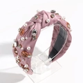 Detailed view of pink knotted headband with pearls, rhinestones and basketball charms - Lotus root pink
