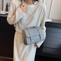 Chic grey PU leather crossbody bag with flap and dual buckle straps on white dress - Gray