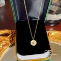Elegant gold pearl necklace featuring a heart-shaped pendant on black velvet display - X559 Gold Heart Round Disc
