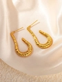 Macro detail of hammered gold U-shape earrings on elegant silk and stone textures - Gold Hammered U-Shape Earrings