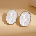 Macro detail of silver geometric oval earrings with white mother-of-pearl texture - Irregular Resin Stud Earrings with Silver Pin / White/Silver