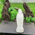 Detailed close-up of 10cm hand-carved clear crystal Virgin Mary statue on a wood base - White Crystal