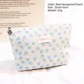 Blue hexagonal lace makeup bag with floral patterns and shell zipper pull - Blue Hexagonal Bag