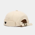 Detail view of beige canvas brimless cap with heart embroidery and metal buckle adjuster - Beige