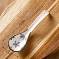 Japanese ceramic soup spoon with blue floral pattern on wood background, 15.5cm size - Blue Gray Floral