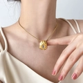 Detail of gold lava textured necklace with clear zircon stone worn on a model - Irregular Small Zirconia