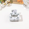 Detail view of a white acrylic hair claw clip with blue and black butterfly prints - 5cm Square Block / Light Green Butterfly