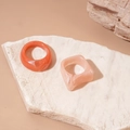 Detailed macro of coral orange and pale pink marble resin geometric acrylic rings - Pink/Rose Red (2-Piece Set)