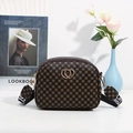 Brown heart-buckle crossbody small bag with colorful wide shoulder strap on aesthetic table - Coffee