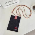 Detail of blue denim crossbody bag featuring red plaid flap and cute cherry embroidery - Dark Blue Cherry