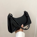Chic black patent leather baguette shoulder bag with glossy finish and modern minimalist style - Black