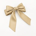 Detailed close-up of champagne satin bow hair clip on a clean white background - Khaki