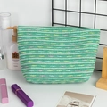 Detail van geweven toilettas met groene witte strepen en kleurrijke polkadots - Lichtgroen