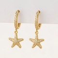 Close-up of gold starfish earrings with micro-pave white zircon stones for women - O-Starfish