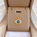 Gold evil eye pendant necklace with blue enamel and tassels in a jewelry gift box - Eyelash Evil Eye Style