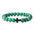 Detailed close-up of a green malachite beaded bracelet with a black cross pendant charm - Peacock
