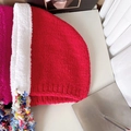 Detail of red and white plush knit hat with colorful pom-poms and fringe tassels - Red with White Edge