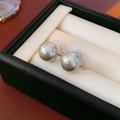 Close-up of pearl ear clips with silicone pads in a black leather jewelry box - Diameter 12mm / Silver Base Grey Pearl (12mm)