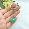 Close-up of heart-shaped green aventurine stone keychain with polished silver metal ring - Green Aventurine